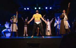 Martin Blais visible in a stage photo from La Guerre des Cônes at Fringe 2025, view 11