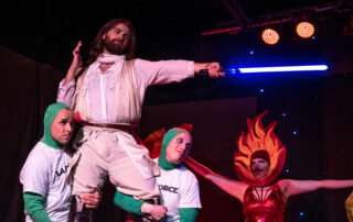 Martin Blais visible in a stage photo from La Guerre des Cônes at Fringe 2025, view 5